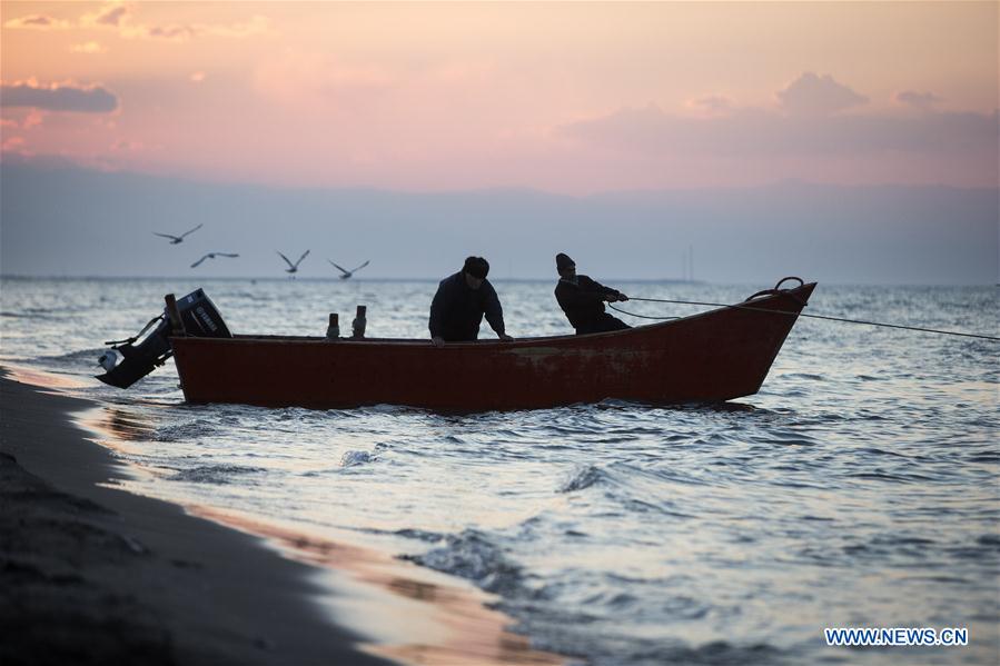 Iranian fishermen work at the Caspian sea beach near Anzali Port, northern Iran, on March 27, 2017. (Xinhua/Ahmad Halabisaz) Iranian fishermen work at the Caspian sea beach near Anzali Port, northern Iran, on March 27, 2017. (Xinhua/Ahmad Halabisaz)